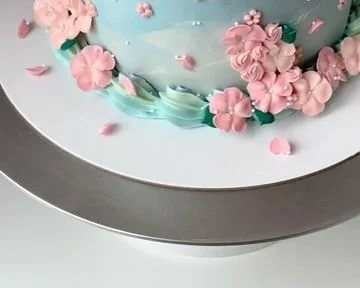 Spring cake decorated with buttercream flowers for a festive celebration.