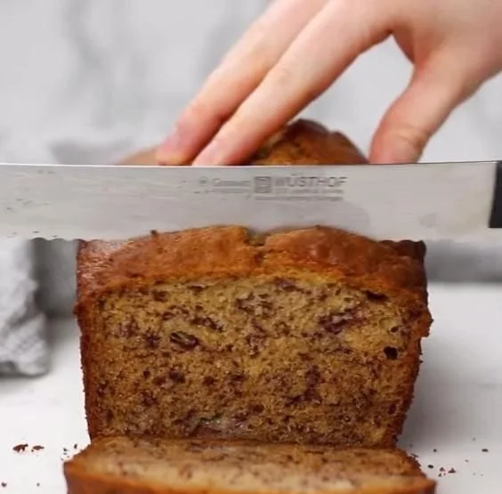 Loaf of homemade banana bread on a wooden table