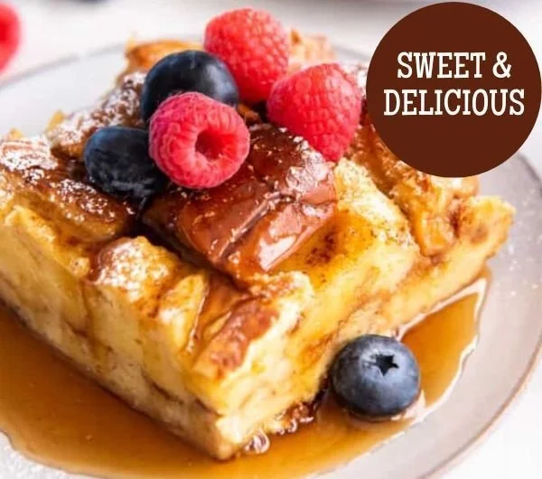 Delicious Brioche French Toast Casserole topped with syrup and berries