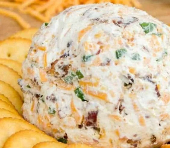 Cheddar Ranch Cheeseball served with crackers on a platter.