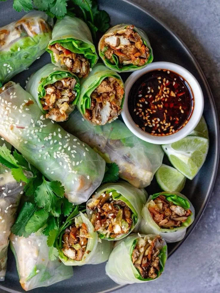 Plate of golden Chicken Spring Rolls with dipping sauce