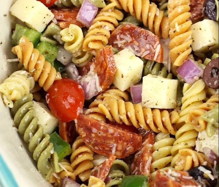 Bowl of classic pasta salad with vibrant vegetables and dressing