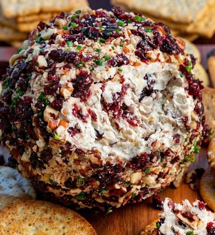 Cranberry pecan cheese ball served with crackers and festive garnishes