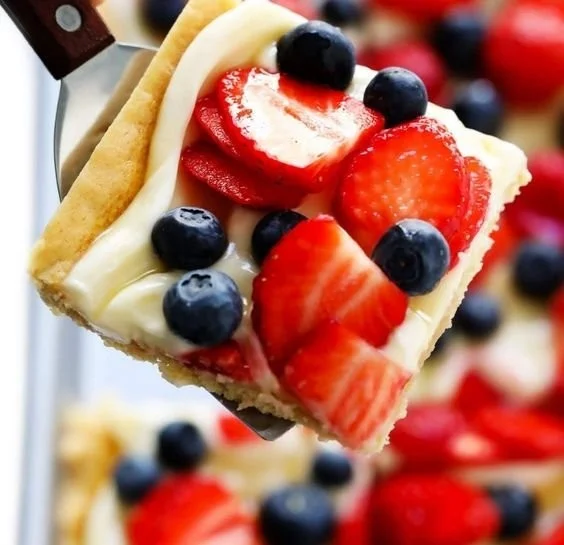 Colorful easy fruit pizza topped with fresh fruits on a sweet crust.