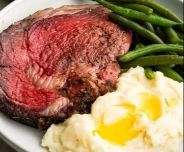 Deliciously cooked standing rib roast ready to be served with sides