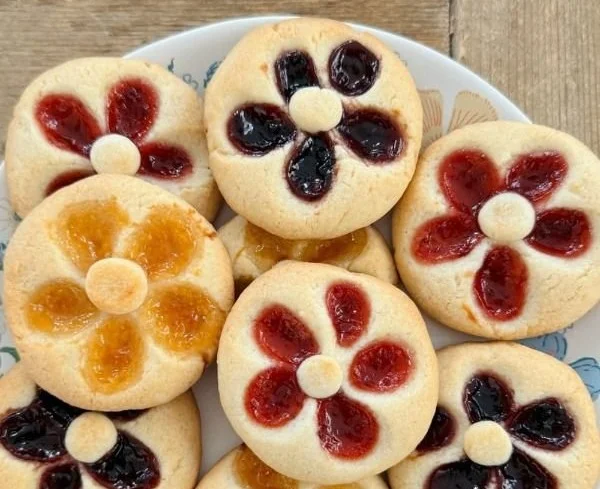 Flower Jam Thumbprint Cookies topped with vibrant fruit jam filling