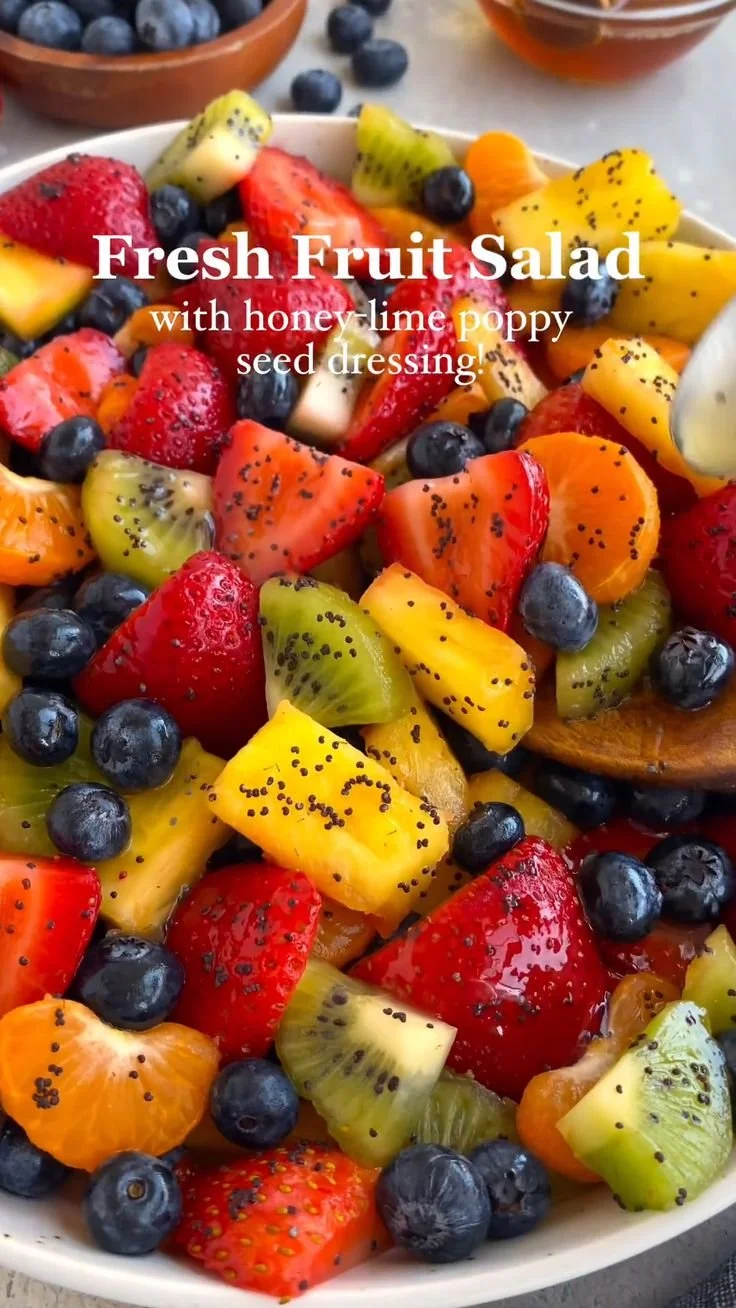 Fresh fruit salad with honey lime poppy seed dressing in a vibrant bowl