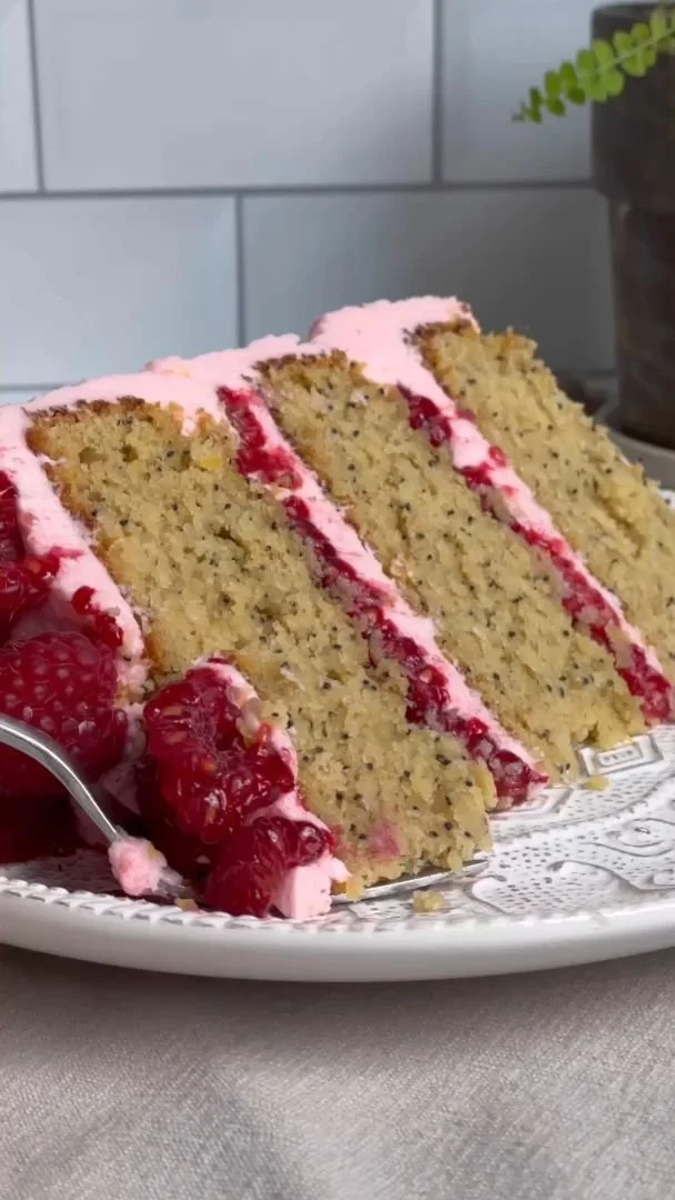 Gluten Free Lemon Raspberry Cake 3 Gluten-free lemon raspberry cake topped with fresh raspberries and lemon zest.