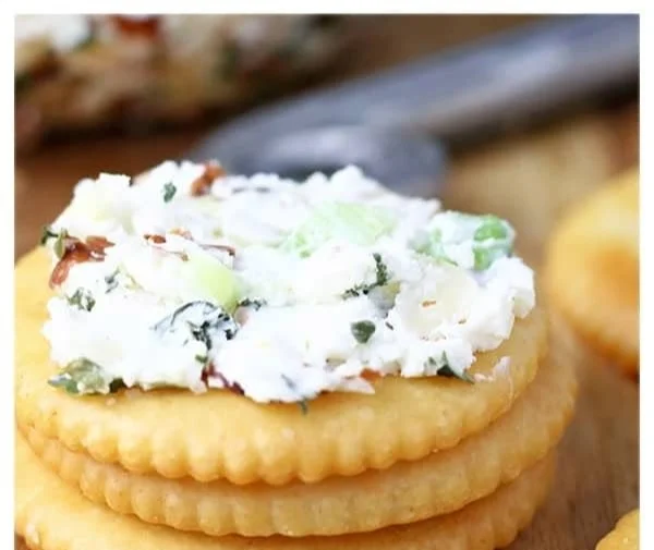 Delicious green onion cheese ball served on a platter with crackers