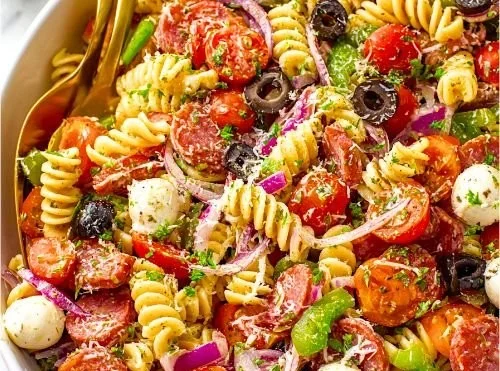 Colorful bowl of Legendary Pasta Salad with fresh vegetables and dressing