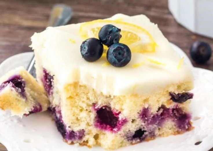 Delicious Lemon Blueberry Cake topped with fresh blueberries and lemon zest