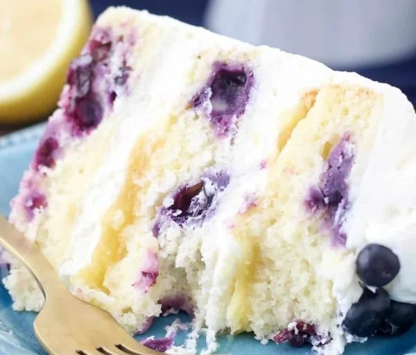 Delicious Lemon Blueberry Cake topped with fresh berries and lemon glaze