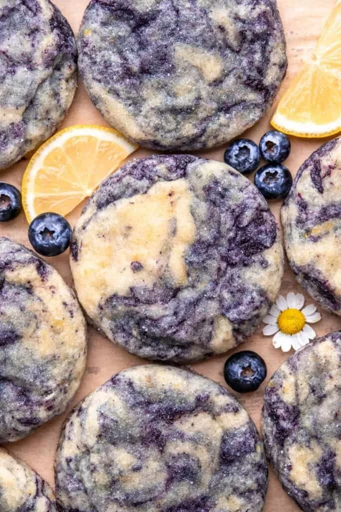 Lemon blueberry cheesecake cookies stacked on a plate