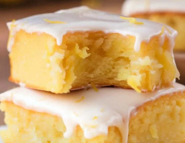 Delicious lemon brownies served with powdered sugar on top.