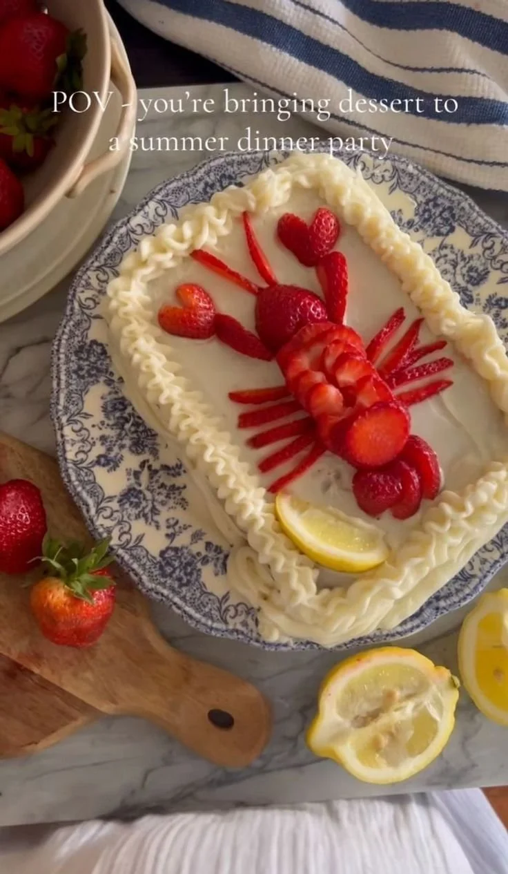 Lemon Cake topped with fresh strawberries and a lemon glaze