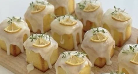 Mini lemon loaves drizzled with icing, showcasing a delicious dessert.