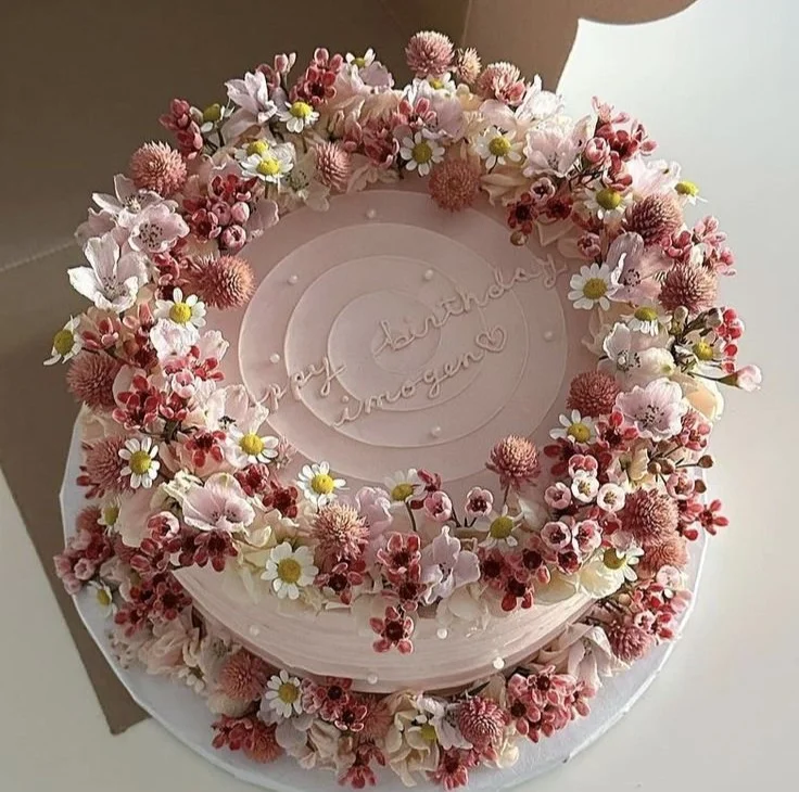 Beautifully decorated Mother's Day cakes with floral designs and personal touches.