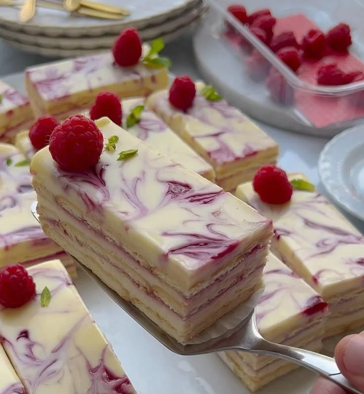 Delicious no-bake raspberry cheesecakes topped with fresh raspberries