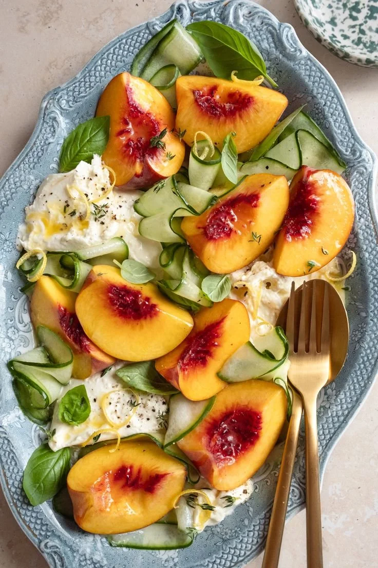 Peach Caprese Salad with Burrata on a rustic table