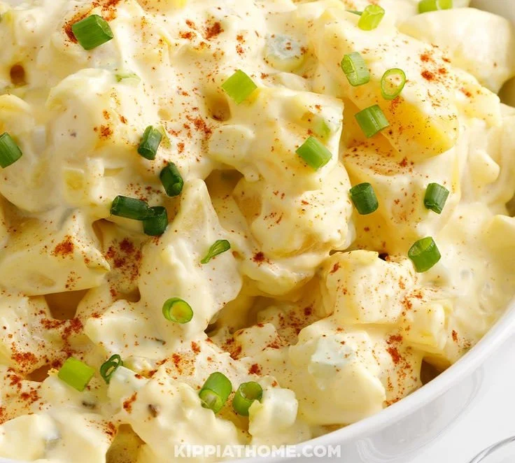 Delicious homemade potato salad garnished with fresh herbs