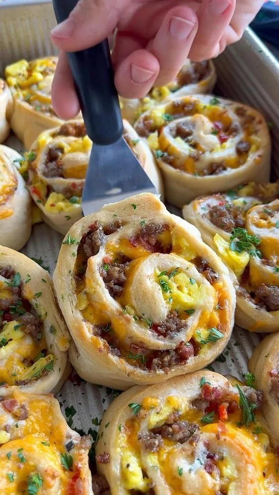 Freshly baked savory breakfast rolls on a wooden table